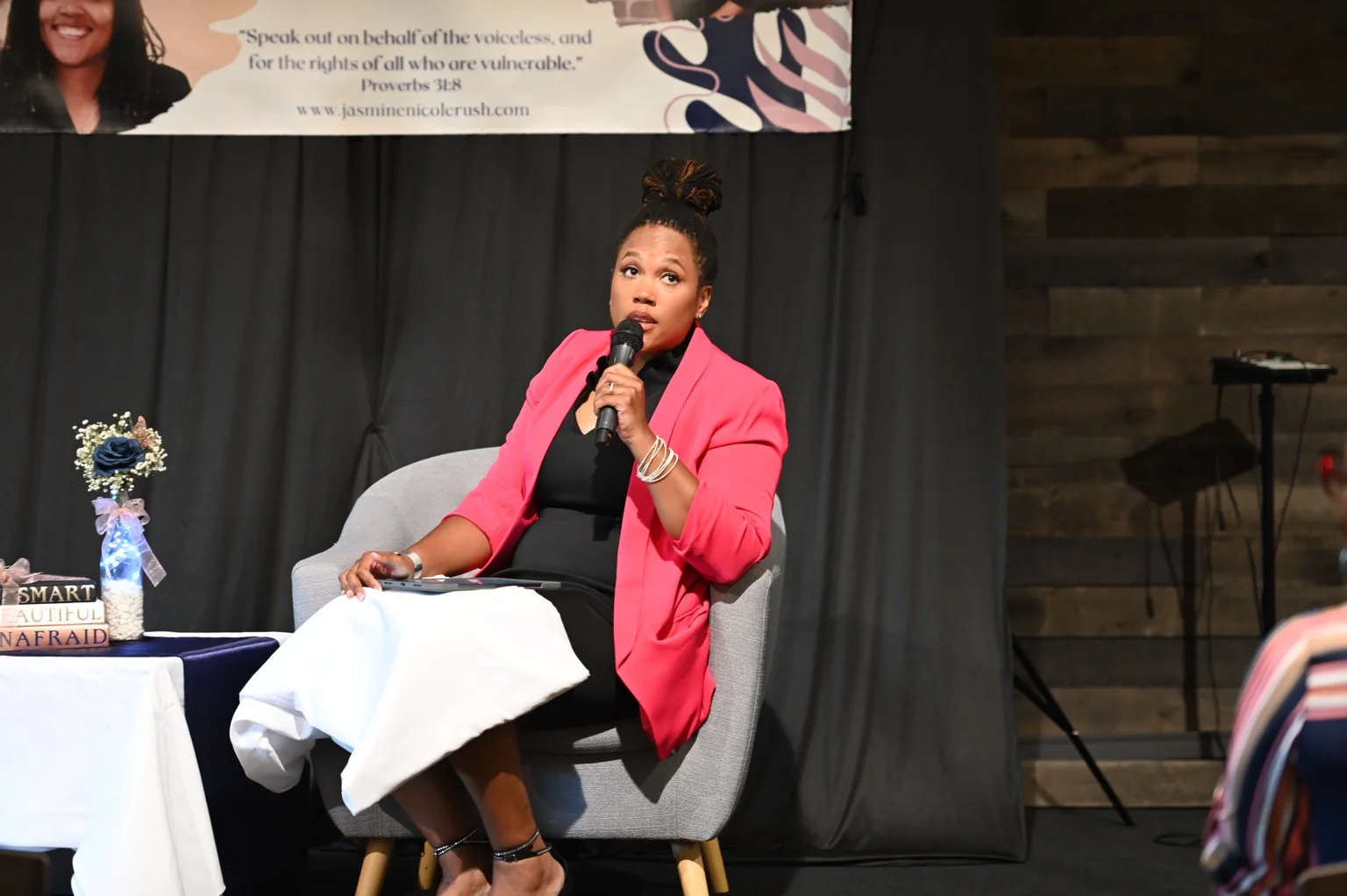 Jasmine in conversation at an event